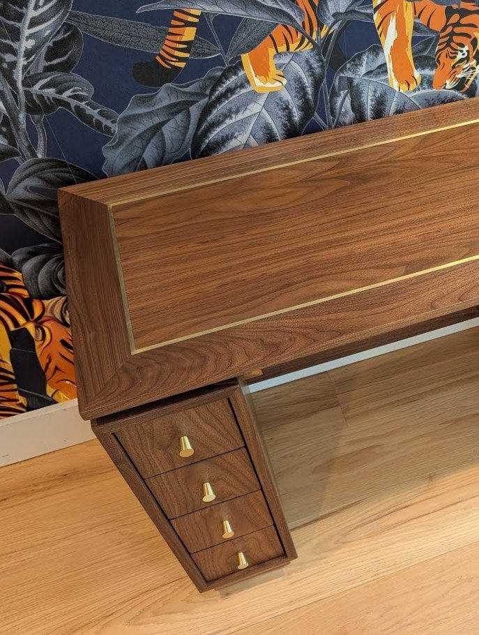 Pedestal desk with continuous grain drawers and brass inlay top