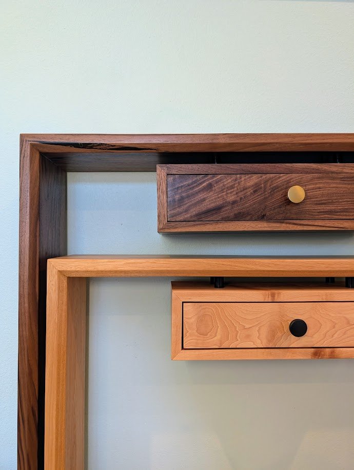 Pecan and walnut waterfall console tables with drawer