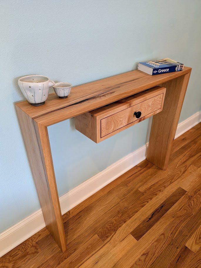 Pecan waterfall console table in room