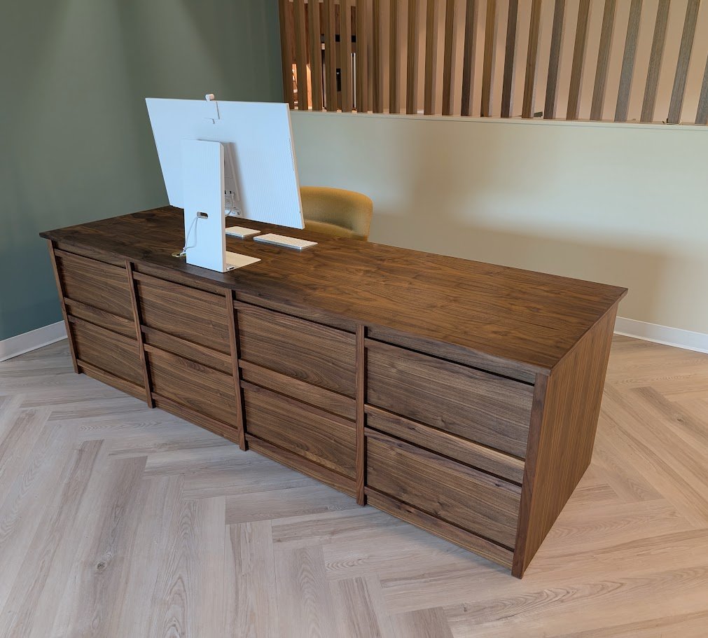 Walnut reception desk with solid walnut grid-pattern front